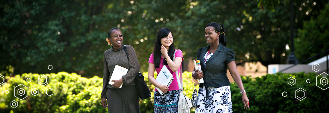 Three international students walking together outdoors at the University of Lynchburg